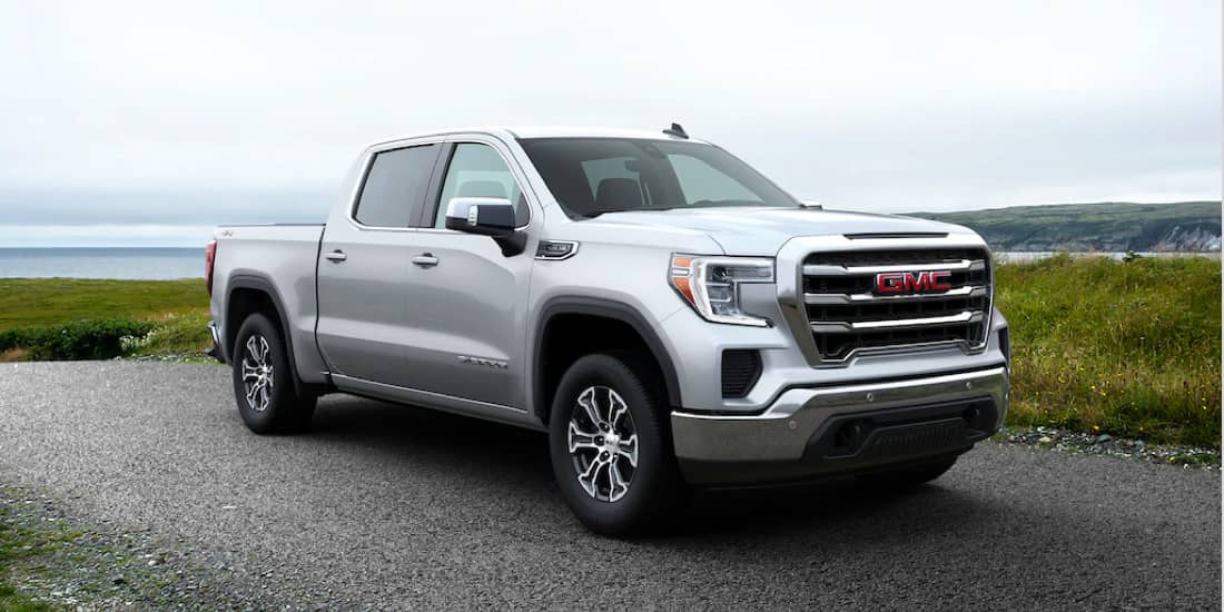 Front facing GMC Sierra 1500 in front of a lake